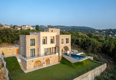 an aerial view of a house with a swimming pool at White Hill Villa in Masline