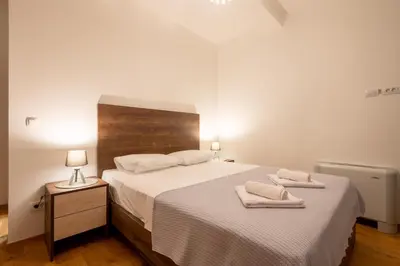 a bedroom with a bed with two towels on it at White Hill Villa in Masline