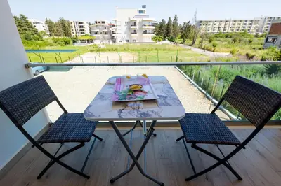 a table and two chairs on a balcony at Reis Apartments in Ulcinj