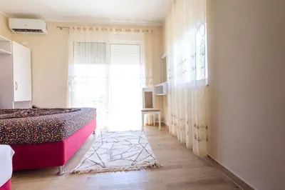 a bedroom with a bed and a window at Reis Apartments in Ulcinj