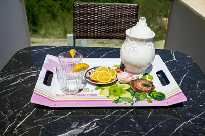 a tray with a plate of food on a table at Reis Apartments in Ulcinj