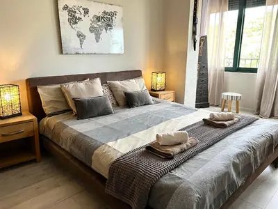 a bedroom with a large bed with two towels on it at Panama apartment in Ulcinj
