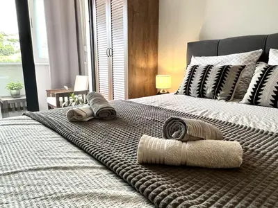 a bedroom with a bed with two towels on it at Panama apartment in Ulcinj