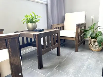 a room with a table and a chair and plants at Panama apartment in Ulcinj