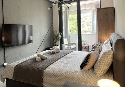a bedroom with a bed with two towels on it at Panama apartment in Ulcinj