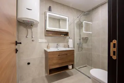 a bathroom with a sink and a shower at Dulamerovic Hotel in Ulcinj