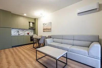 a living room with a couch and a table at Dulamerovic Hotel in Ulcinj