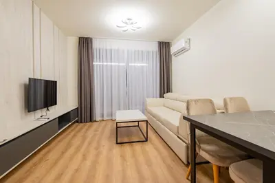 a living room with a couch and a tv and a table at Dulamerovic Hotel in Ulcinj