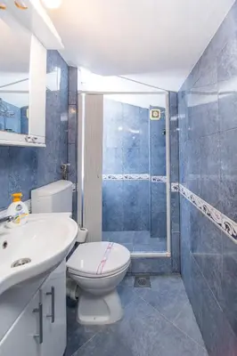 a bathroom with a toilet and a sink and a shower at Apartments Kovačević in Petrovac na Moru