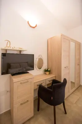a room with a desk with a television and a chair at Apartments Kovačević in Petrovac na Moru