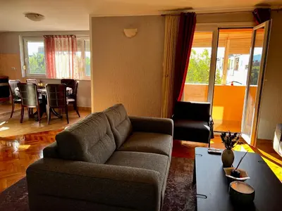 a living room with a couch and a table at City Center Square DeLuxe Nest in Podgorica