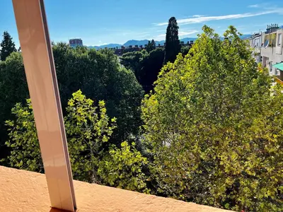 a view of some trees from a balcony at City Center Square DeLuxe Nest in Podgorica