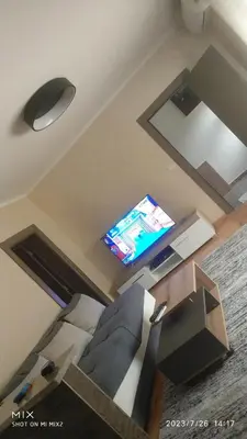 a living room with a couch and a flat screen tv at Prestige in Podgorica