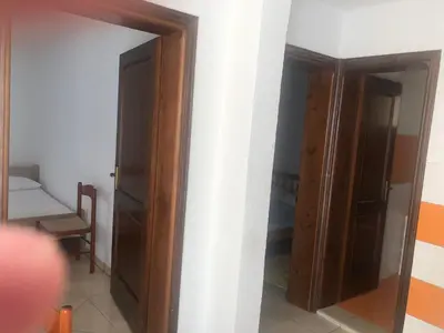 a room with an open door and a closet at Apartment Nafija. No 2 in Donji Štoj
