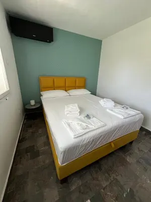 a bedroom with a bed with white sheets at Casa Cristiano in Sutomore