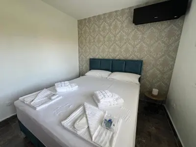 a bed with white towels on it in a room at Casa Cristiano in Sutomore