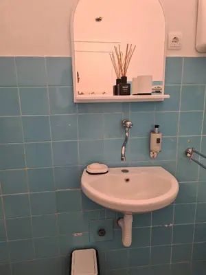 a bathroom with a sink and a mirror at Casa Cristiano in Sutomore