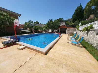 a swimming pool with lounge chairs in a backyard at Sunset Pool Retreat in Zagrađe