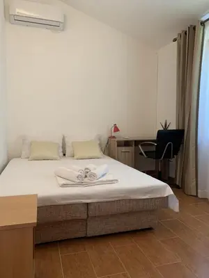 a bedroom with a bed with two towels on it at Sunset Pool Retreat in Zagrađe