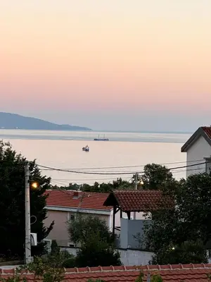 a boat in the water at sunset at Sunset Pool Retreat in Zagrađe