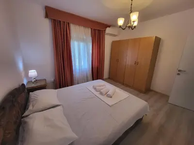 a bedroom with a bed with two towels on it at Sunset Pool Retreat in Zagrađe