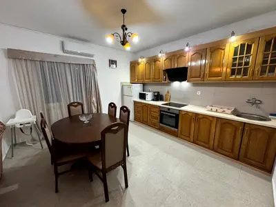 a kitchen with a wooden table and a kitchen with a sink at Sunset Pool Retreat in Zagrađe