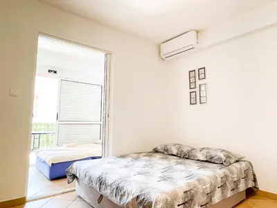 a bedroom with a bed and a window at Apartment Anita - Budva in Budva