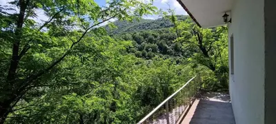 a balcony of a house with a view of a mountain at Rijeka Crnojevica Apartment Vujovic in Rijeka Crnojevića