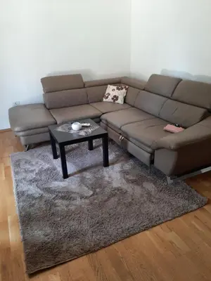 a living room with a couch and a coffee table at Apartman Podgorica in Podgorica