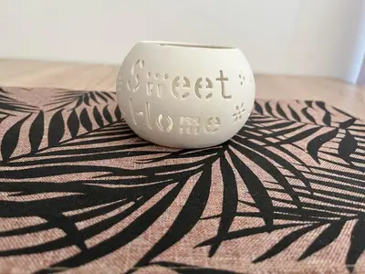 a white vase sitting on top of a rug at Apartman Podgorica in Podgorica