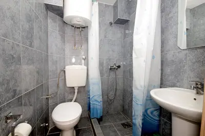 a bathroom with a toilet and a sink at Apartments Pavlovic in Petrovac na Moru