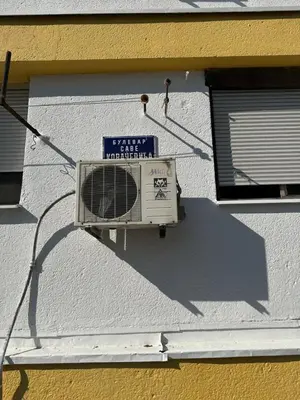 a building with a fan on the side of it at Large Centre apartment in Podgorica