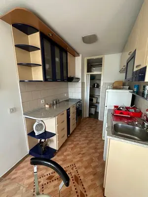 a small kitchen with a sink and a refrigerator at Large Centre apartment in Podgorica
