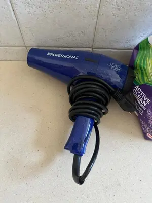 a blue electric hair dryer sitting on a counter at Large Centre apartment in Podgorica