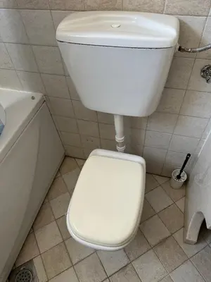 a white toilet in a bathroom with a sink at Large Centre apartment in Podgorica