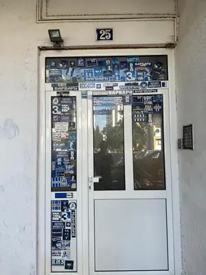 a door with signs on the side of a building at Large Centre apartment in Podgorica