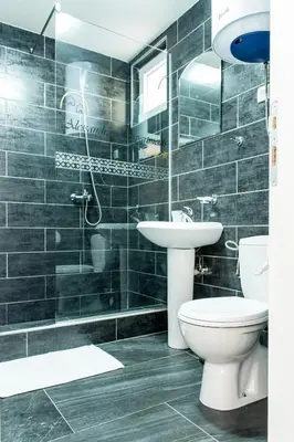 a bathroom with a toilet and a sink at Alessandra Apartments in Sveti Stefan