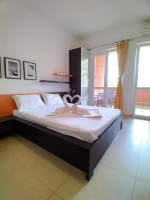 a bedroom with a large bed with a towel on it at Alessandra Apartments in Sveti Stefan