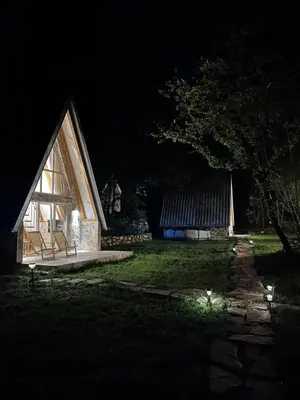 a small house at night with its lights on at Vukova dolina apartments in Cetinje