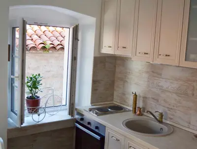 a kitchen with a sink and a window at Bell Tower Apartment in Budva