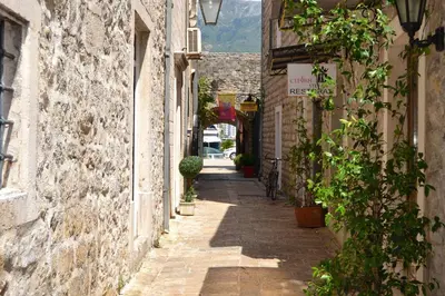 an alley in an old town with buildings at Bell Tower Apartment in Budva