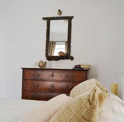 a bedroom with a dresser and a mirror at Bell Tower Apartment in Budva