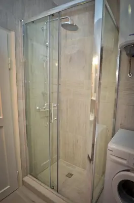 a shower with a glass door in a bathroom at Bell Tower Apartment in Budva