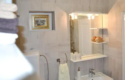 a bathroom with a sink and a mirror at Bell Tower Apartment in Budva