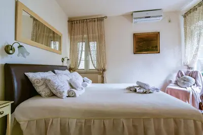 a bedroom with a bed with towels on it at Sea Paradise Apartment in Budva