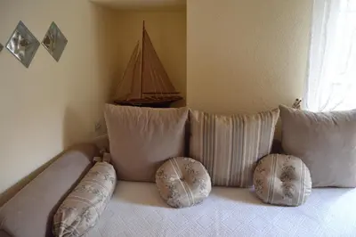 a bed with two pillows and a boat on it at Sea Paradise Apartment in Budva