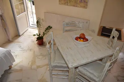 a table and chairs with a bowl of fruit on it at Sea Paradise Apartment in Budva