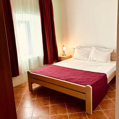 a bedroom with a large bed with a window at Villa Vistamar Lapcici in Budva