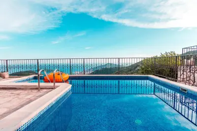 a swimming pool with an orange pool toy on a balcony at Villa Vistamar Lapcici in Budva