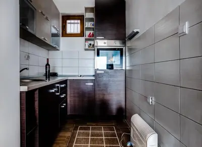 a small kitchen with a sink and a toilet at Villa Ladera Lapcici in Budva
